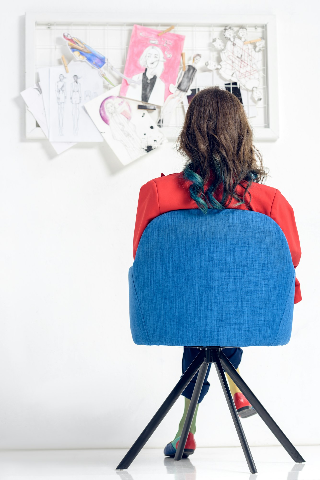 Rear view of woman looking at mood board